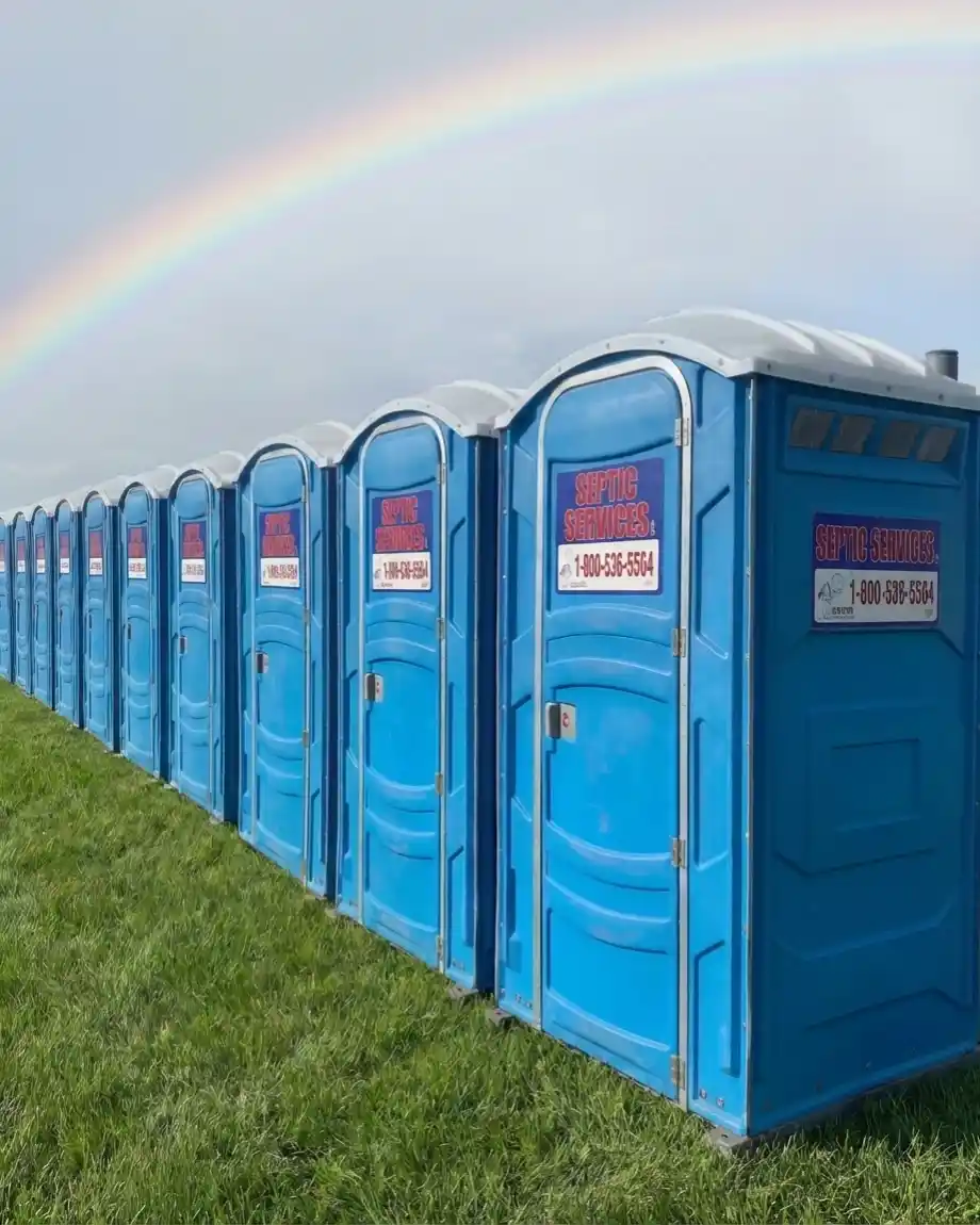 portable restrooms with rainbow above